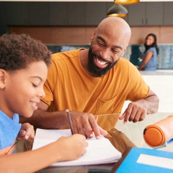up-african-american-father-helping-son-studying-homew-2021-08-28-20-17-23-utc.jpg